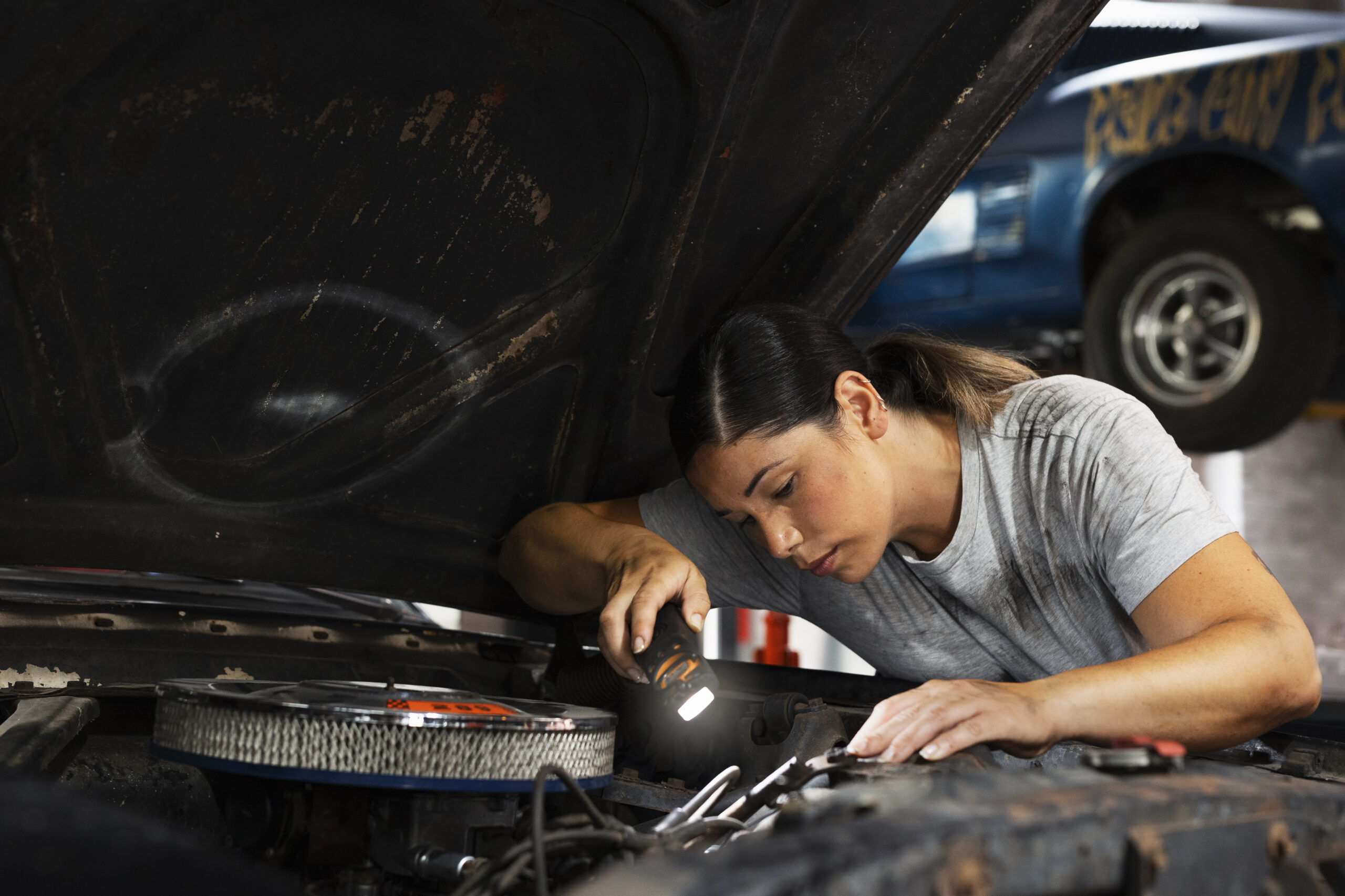 Mechanic woman is repairing car